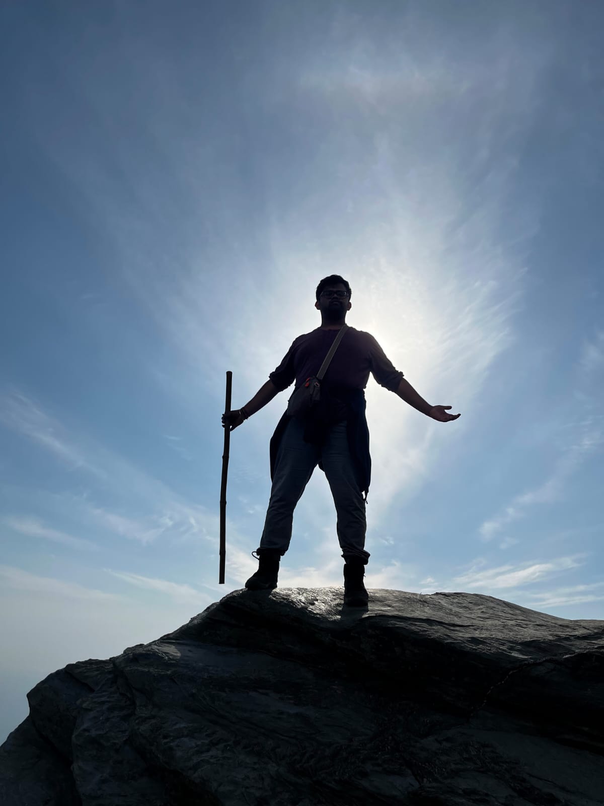 Ritvik Pendyala standing on a summit at sunrise